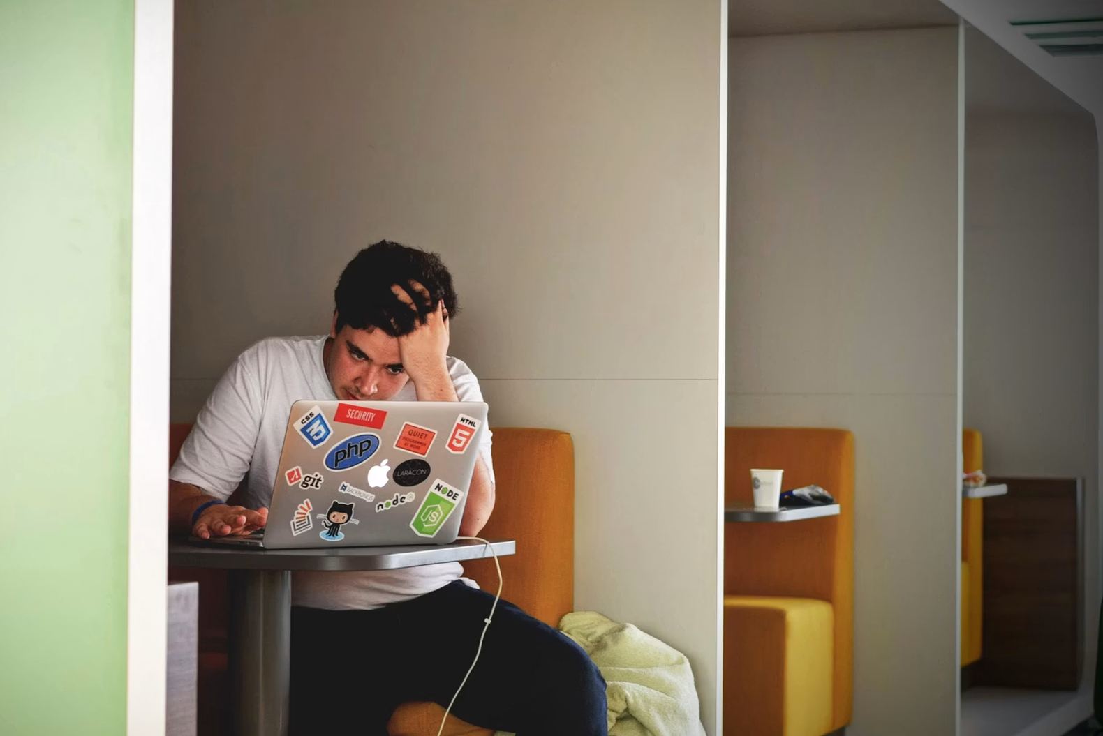 An overwhelmed professional buried under competing tasks and demands